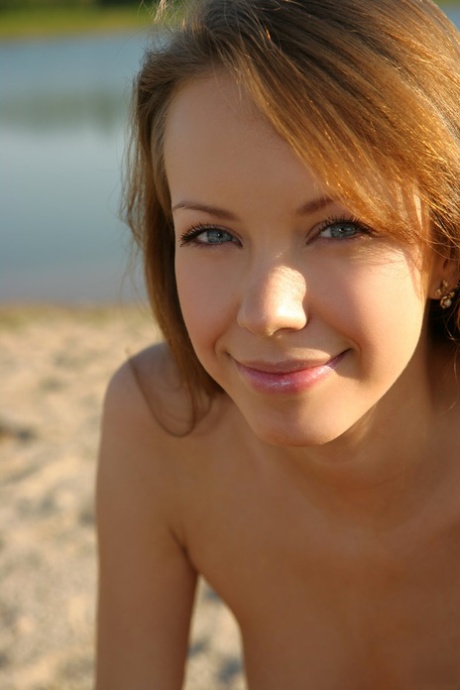 Slim teen with red hair and a pretty face models totally naked on beach sand 48858130
