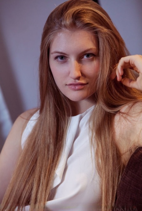 Teen girl with long hair and a pretty face undresses for nude poses 59158828