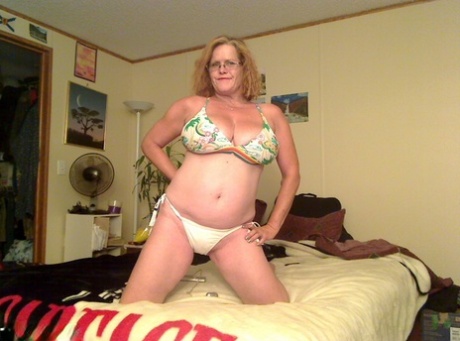Busty Middle-aged amateur Misha MILF rides a dildo on her bed in glasses 36842047