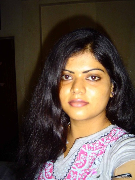 Indian woman Neha takes self shots while she holds her face firm 52567648