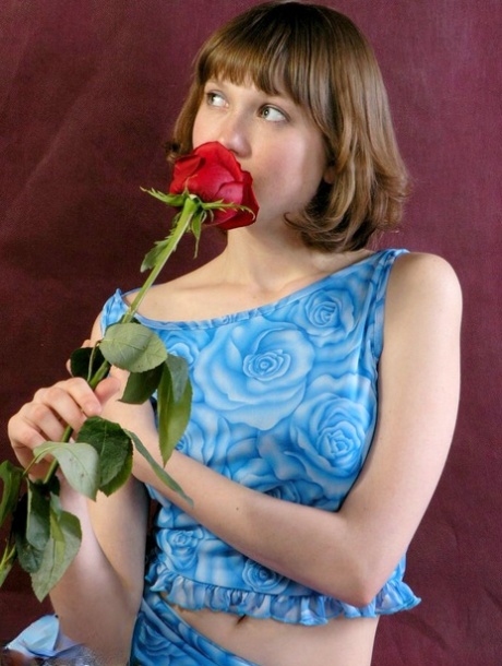 Adorable teen Anabell sniffs a red rose before taking off her clothes 58885910