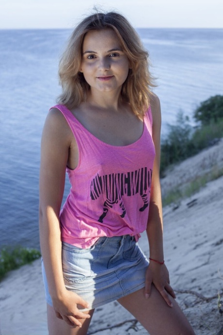 Young amateur Mia gets completely naked on a sandy bank by a coniferous tree 18464567