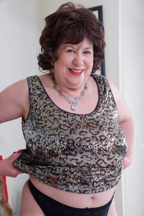 Mature UK woman Speedy Bee gets naked on her bed in a garter belt and hosiery 96580421